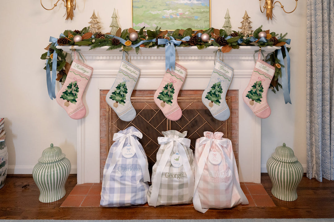 Mantle with Christmas stockings and Namesake Celebrations Santa Sacks for Christmas morning