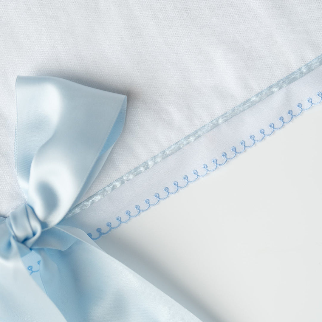 White Pique Crib Rail Topper with Blue Ribbon