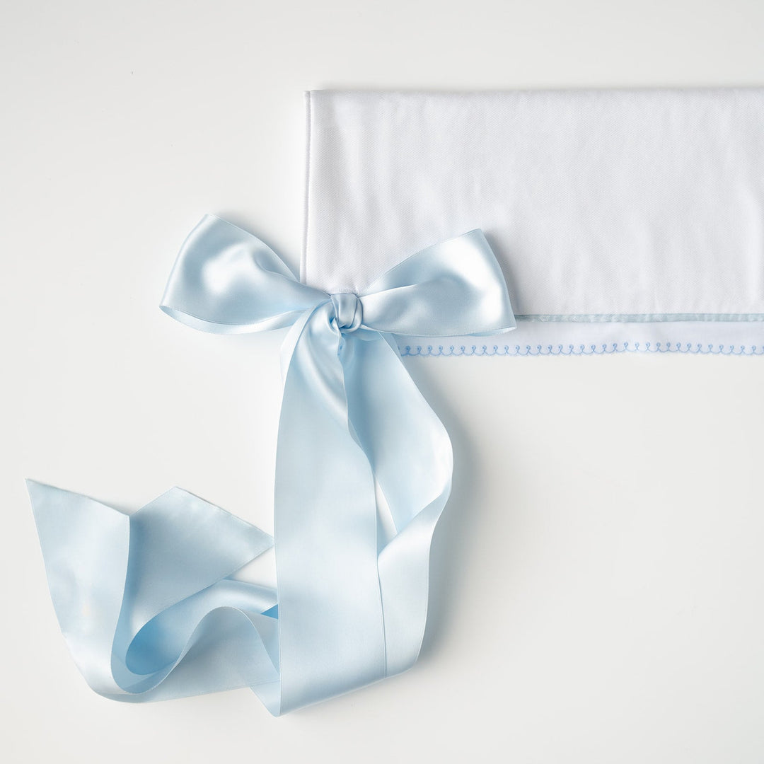 White Pique Crib Rail Topper with Blue Ribbon